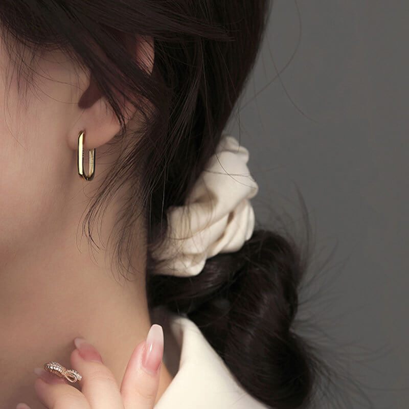 Model wearing Gold Big Paperclip Earrings