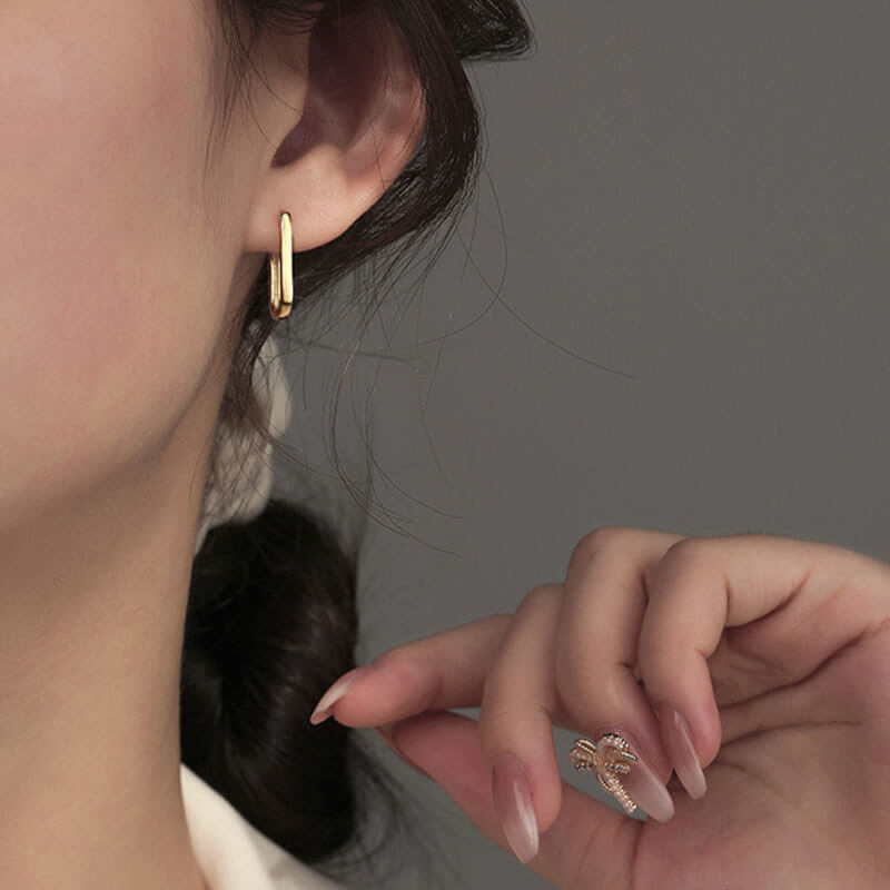 Model wearing Gold Big Paperclip Earrings