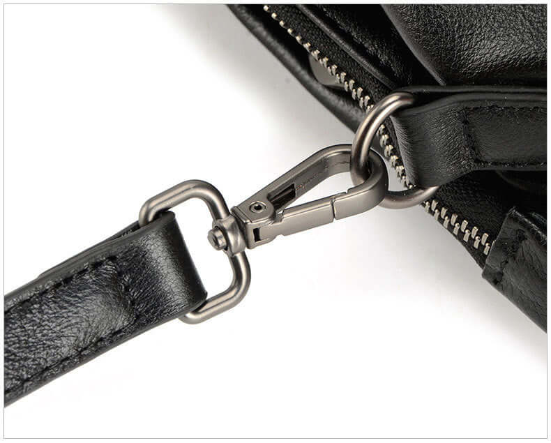 A black leather tote bag strap