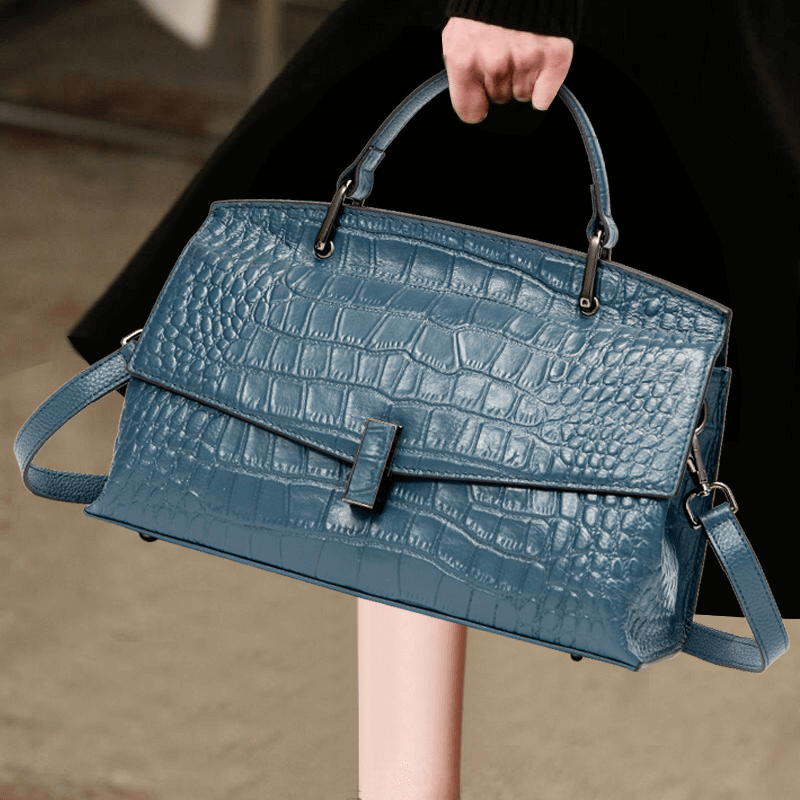 Model carrying a Blue leather shoulder bag