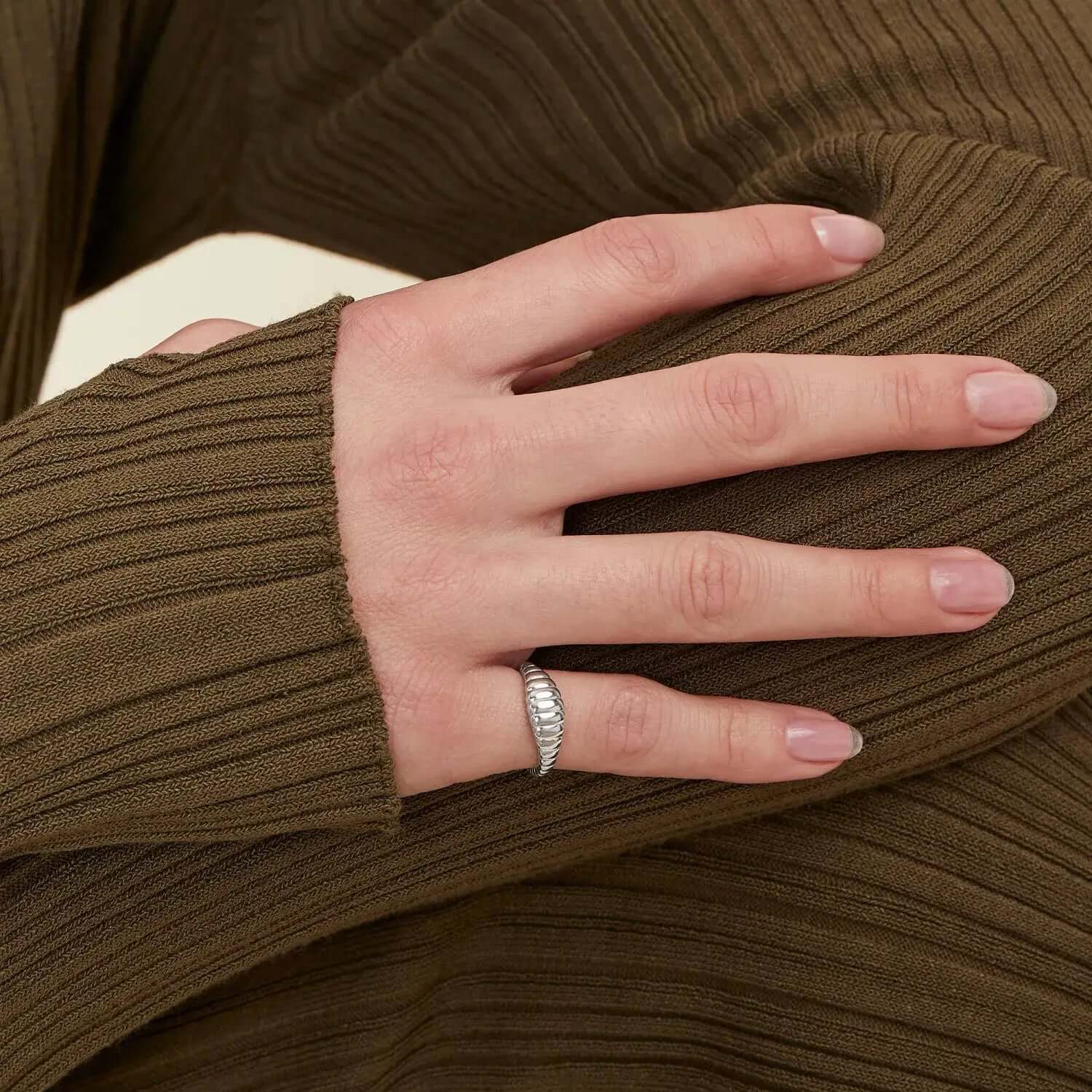 A model showing Croissant shaped ring in silver color