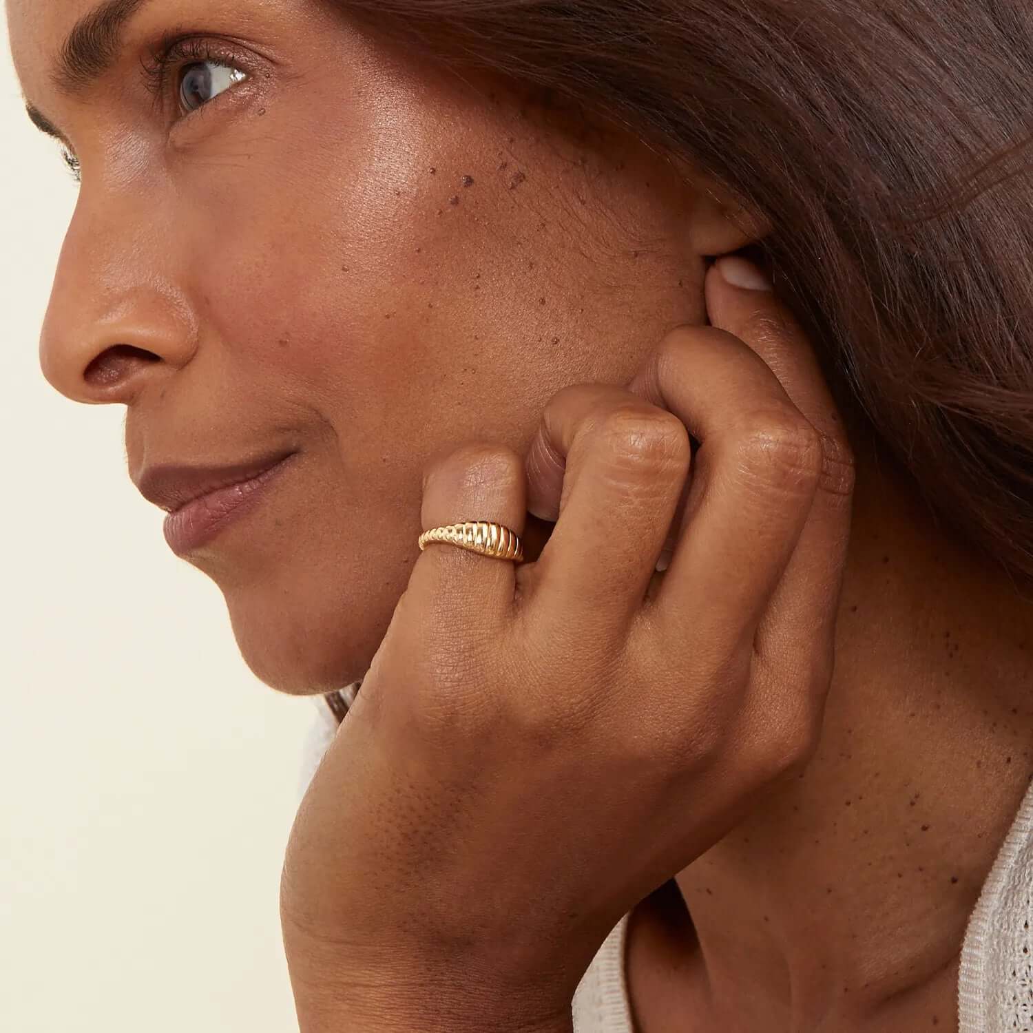 A model wearing Croissant shaped ring in gold color