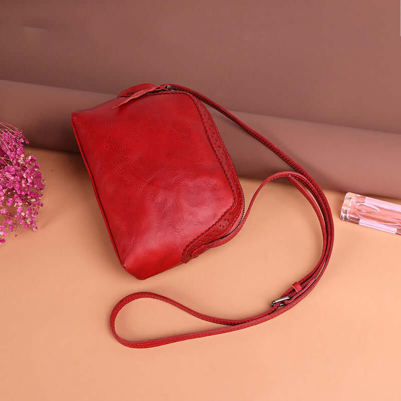 A red leather crossbody bag