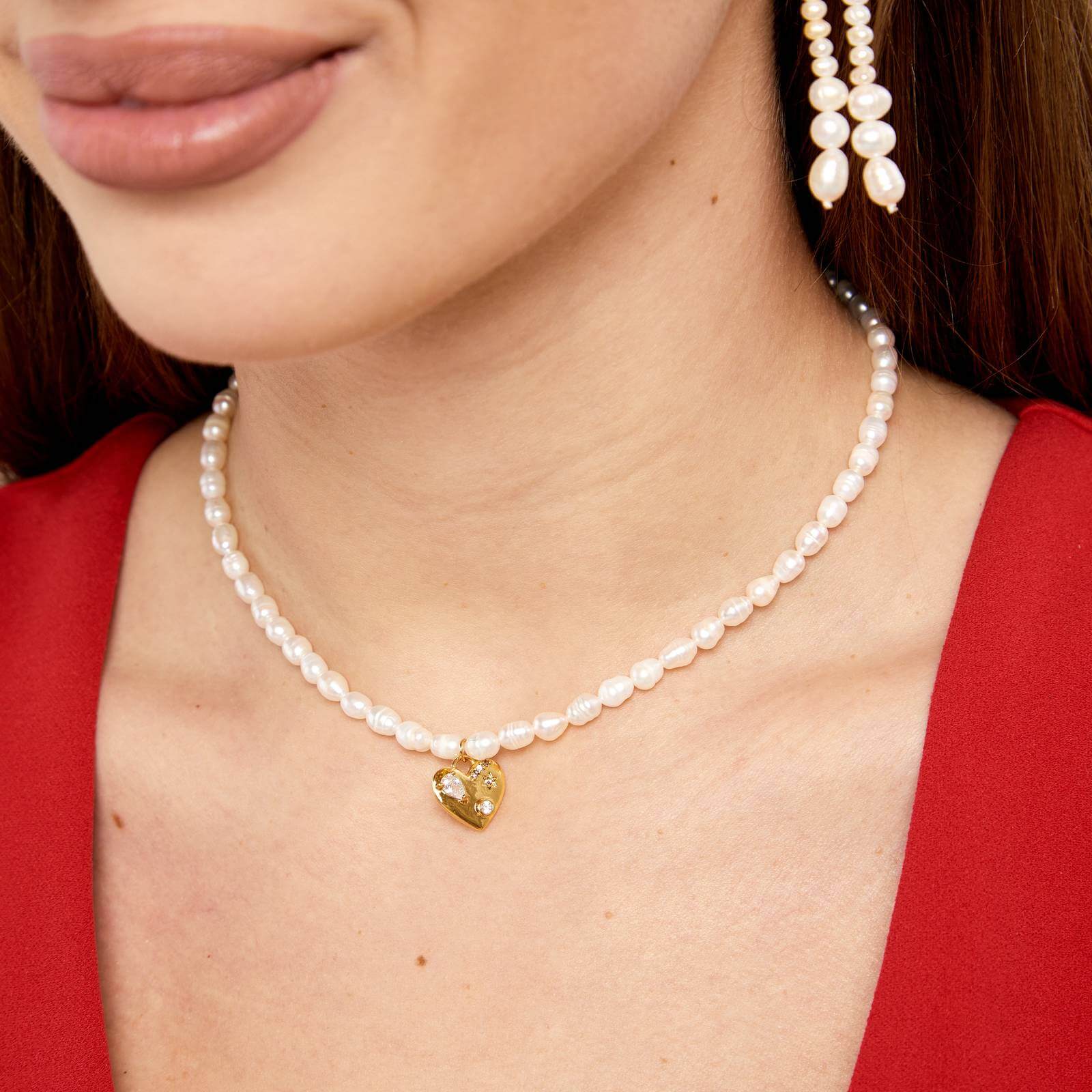 Woman wearing Pearl necklace with heart pendants