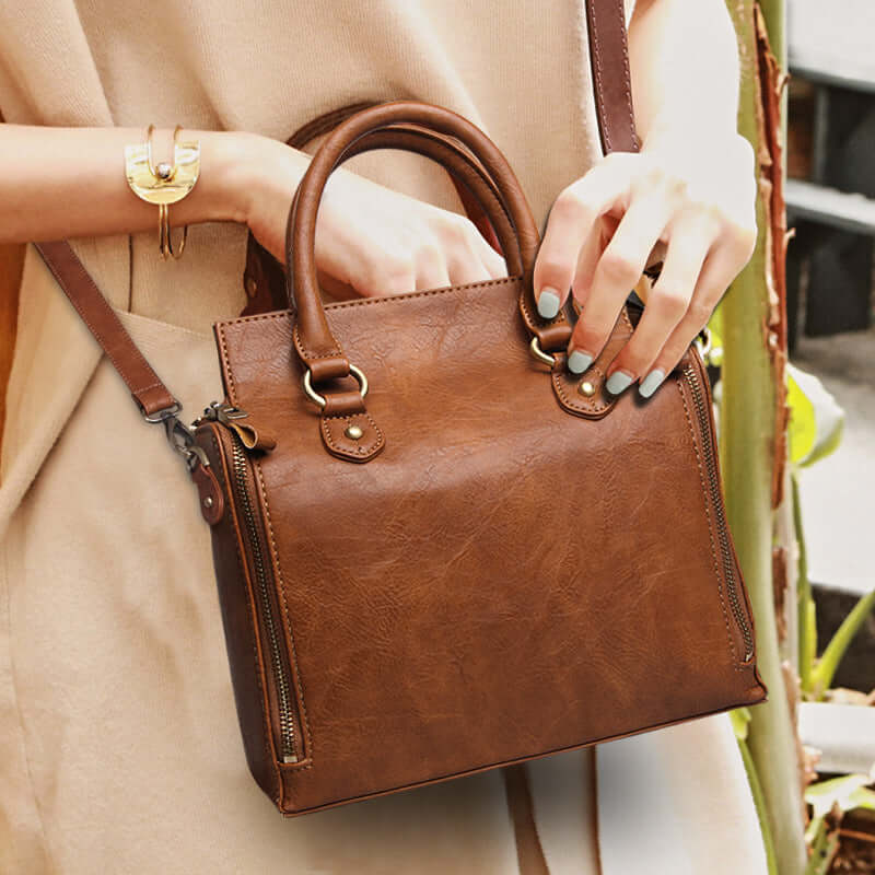 A woman carrying a brown crossbody bag