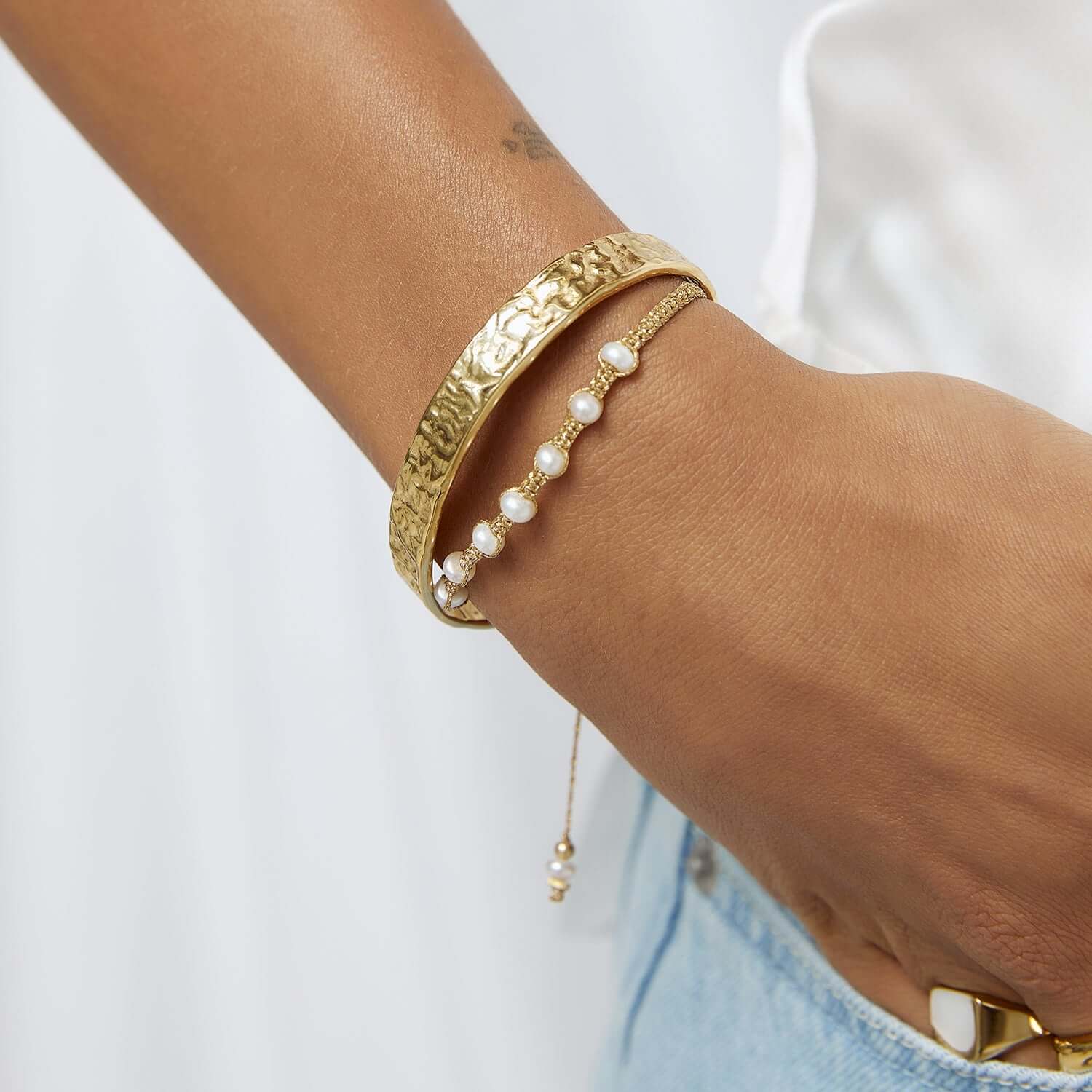 Model wearing Foiled gold cuff bracelet stack