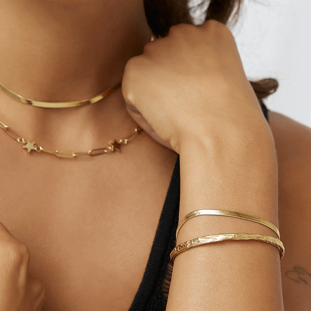 A model wearing Gold snake chain bracelet stack