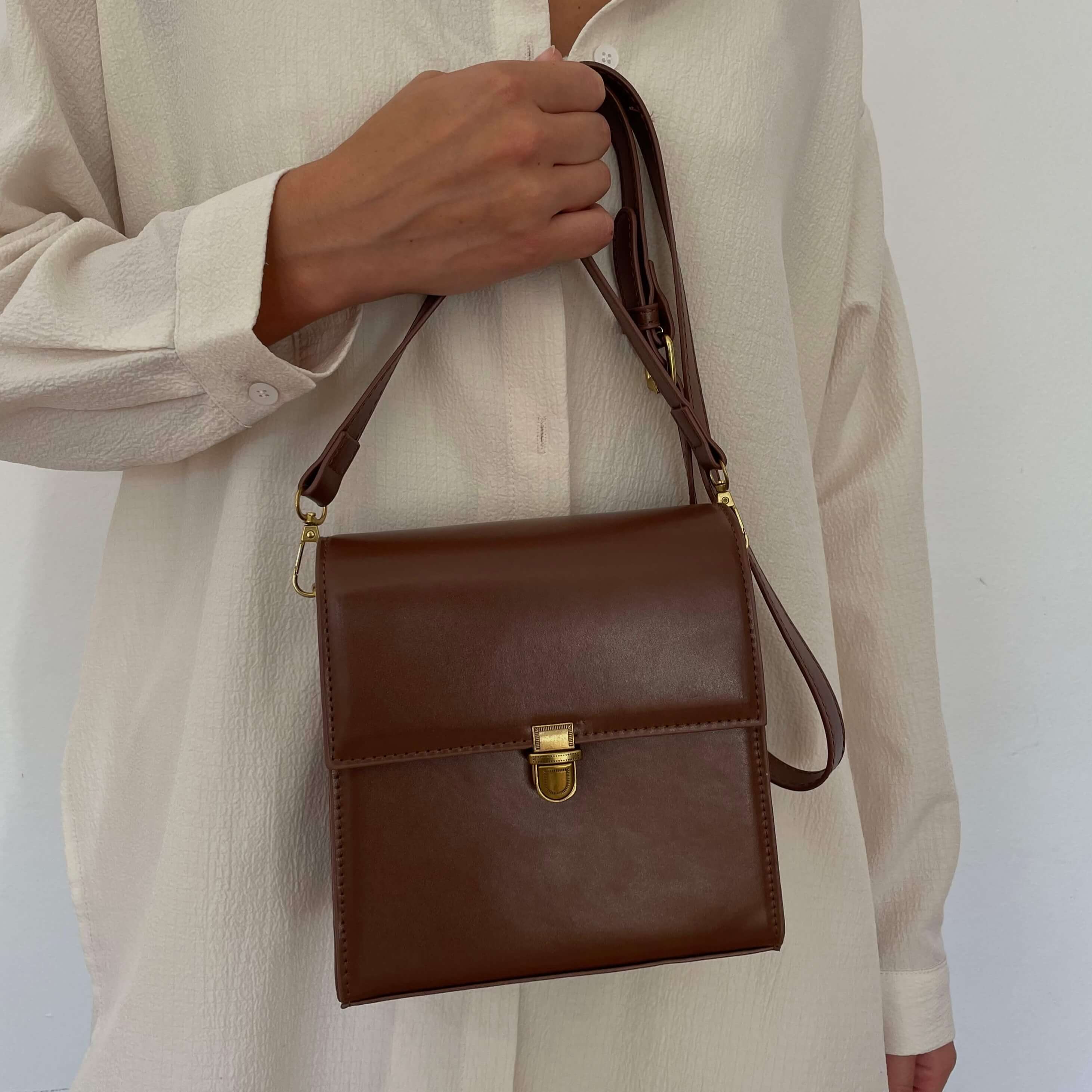 Model wearing Square brown leather crossbody bag