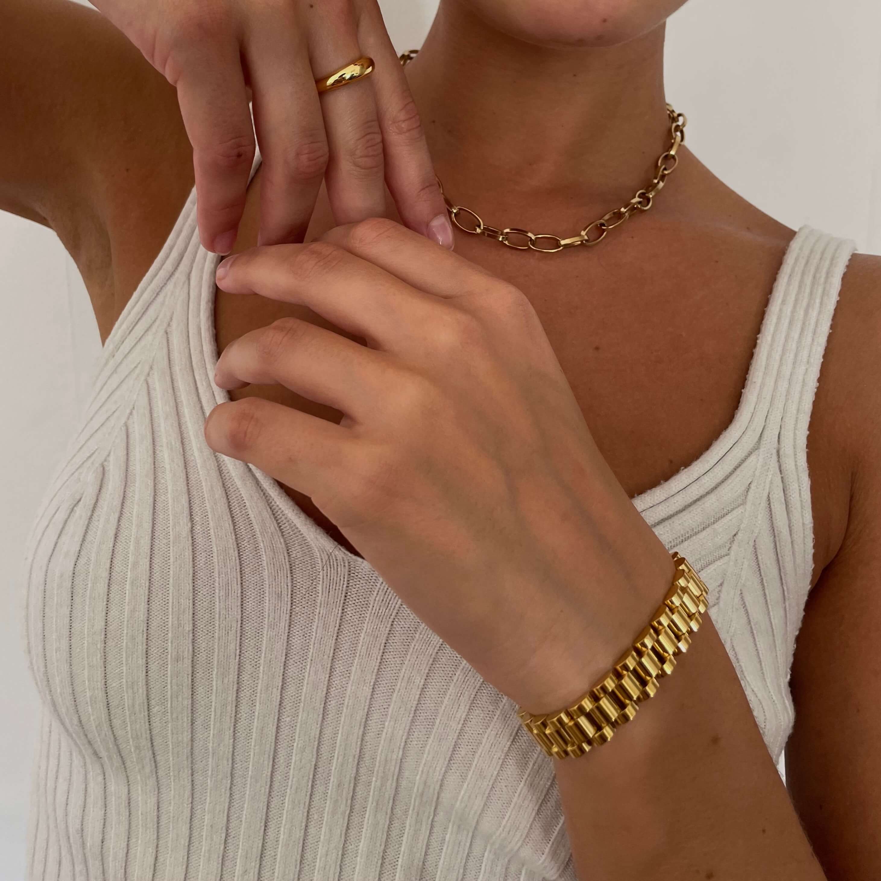 A model wearing a Swiss watch strap bracelet in gold