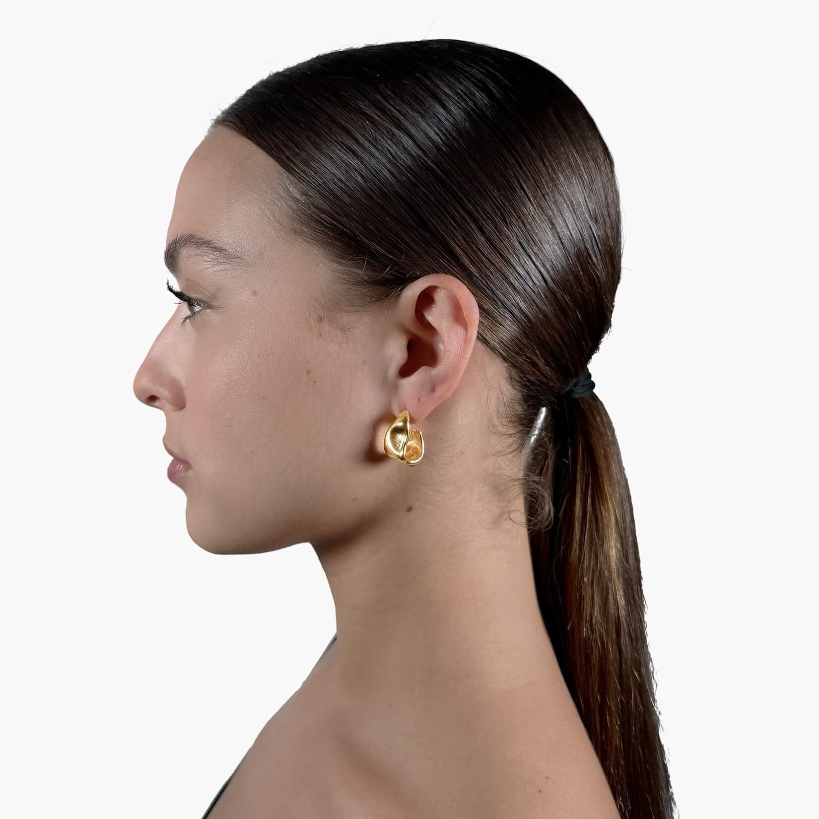 Model wearing Gold Melting Hoop Earrings