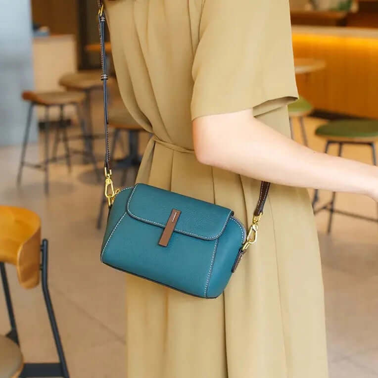 A woman wearing a blue mini crossbody bag