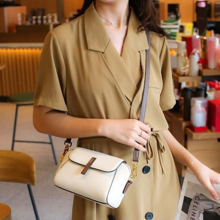 A woman wearing a white mini crossbody bag