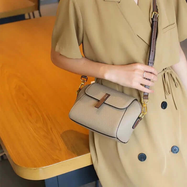 A woman wearing a grey mini crossbody bag