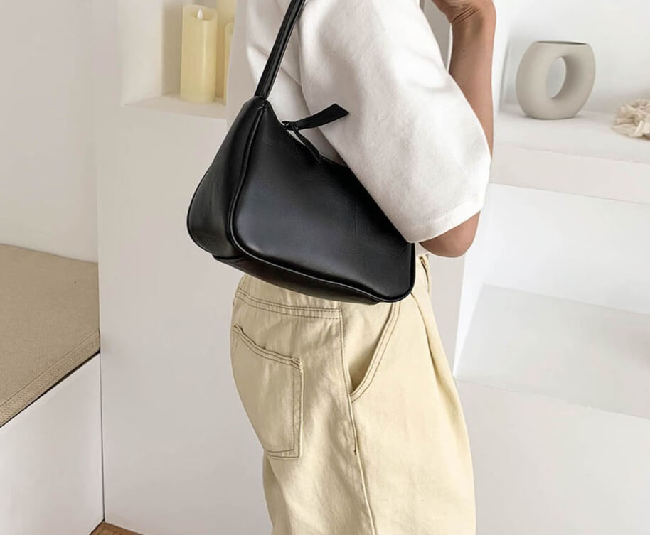 Woman carrying Black shoulder purse