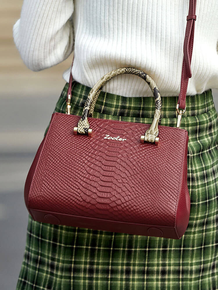 Model carrying Red Snake Skin Handbag