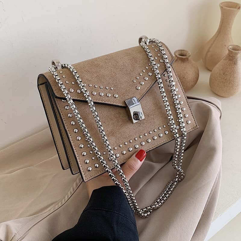 A beige studded vegan leather bag