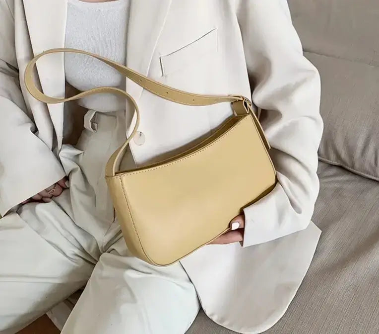 Woman carrying a Beige shoulder purse