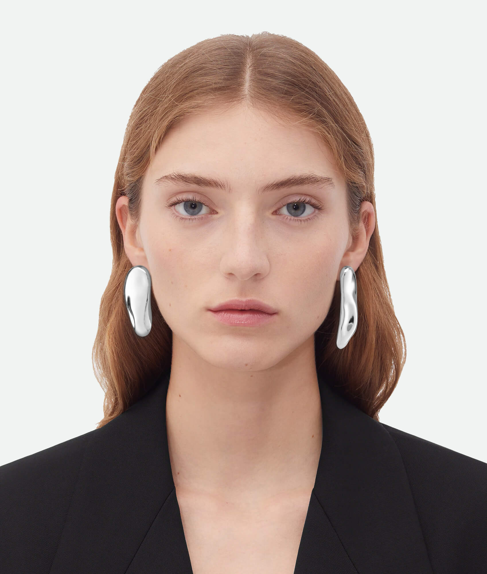 Model wearing Asymmetrical earrings silver