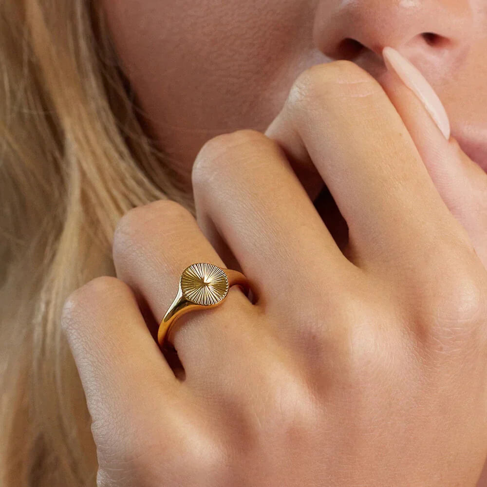 Model wearing Gold sun signet ring